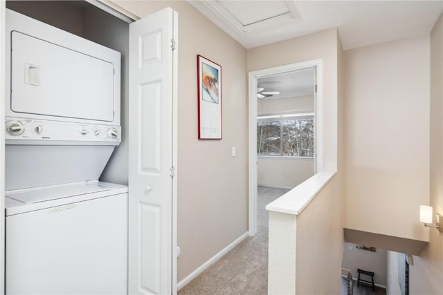 washroom featuring stacked washing maching and dryer and light colored carpet