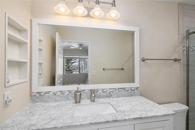 bathroom featuring vanity, ceiling fan, toilet, and walk in shower