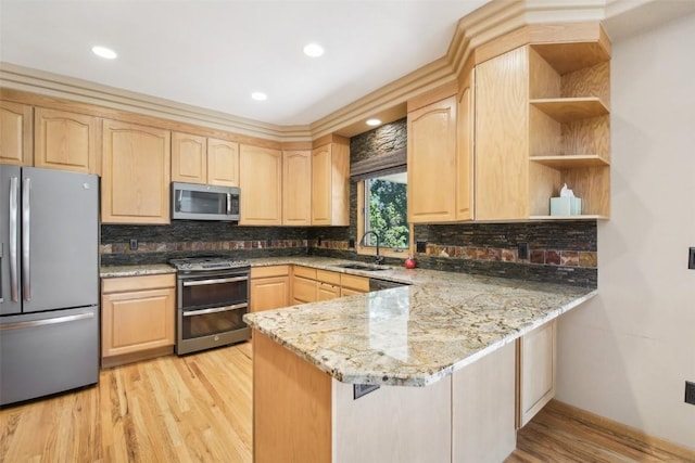 kitchen featuring sink, light brown cabinetry, light stone counters, kitchen peninsula, and stainless steel appliances