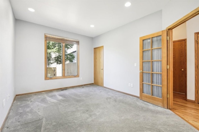 unfurnished room with light colored carpet