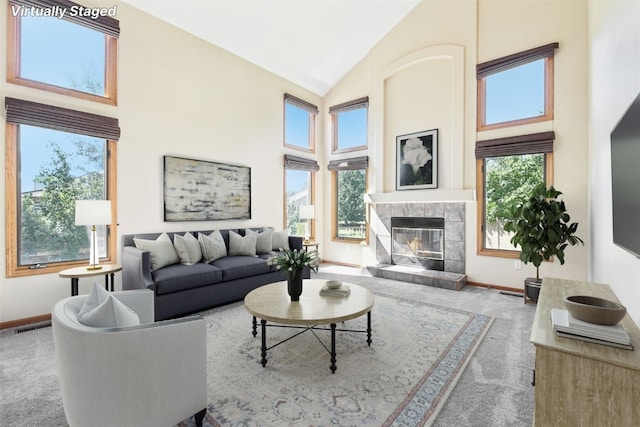 living room with a healthy amount of sunlight, carpet floors, and a fireplace