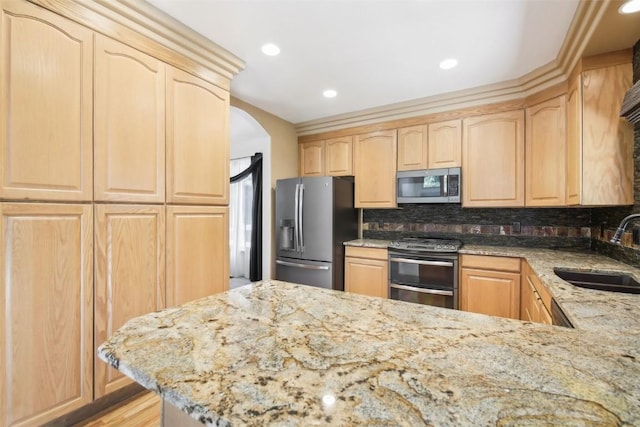 kitchen featuring sink, light brown cabinets, and appliances with stainless steel finishes