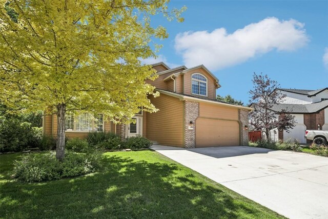 view of front facade featuring a garage and a front lawn