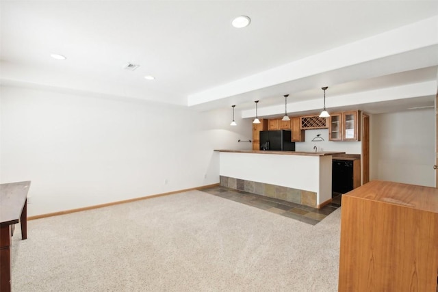 kitchen featuring kitchen peninsula, black fridge, dark carpet, and decorative light fixtures