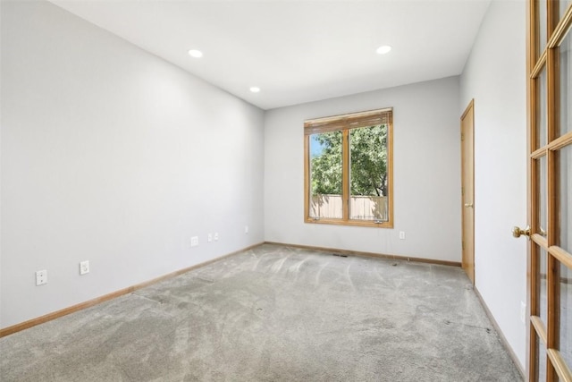 unfurnished room with light colored carpet