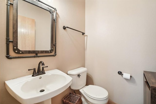 bathroom with sink and toilet