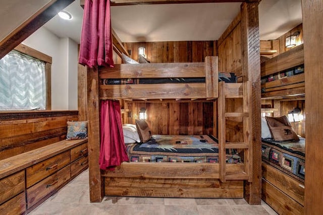 bedroom with wood walls