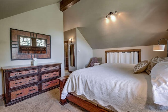 carpeted bedroom featuring lofted ceiling with beams