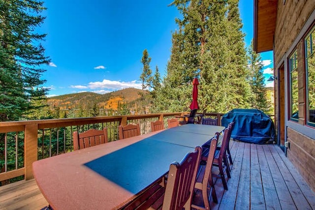 deck with area for grilling and a mountain view