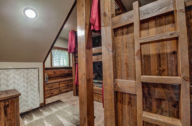 bathroom featuring lofted ceiling