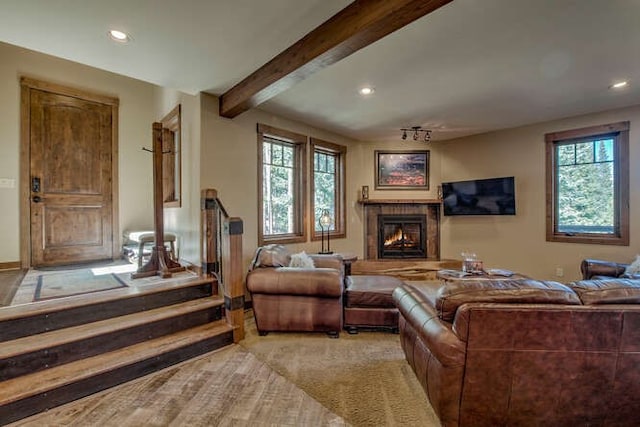 living room featuring light carpet and beamed ceiling