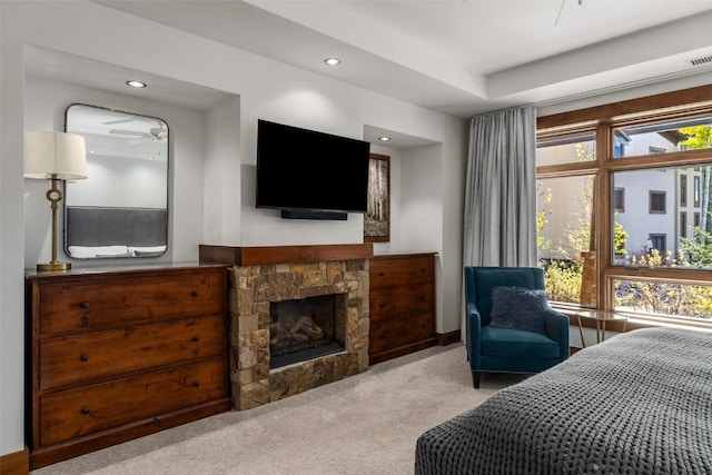 carpeted bedroom featuring a fireplace