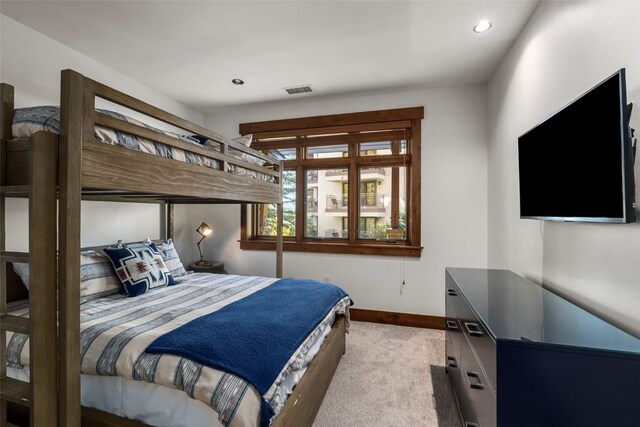 bedroom featuring light colored carpet