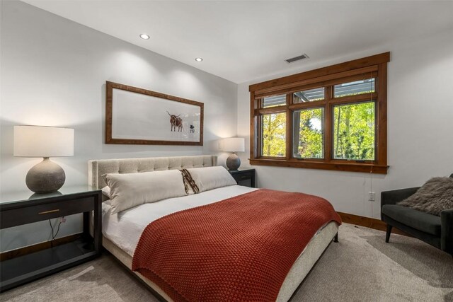 bedroom featuring light carpet