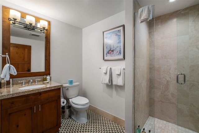 bathroom featuring vanity, an enclosed shower, and toilet