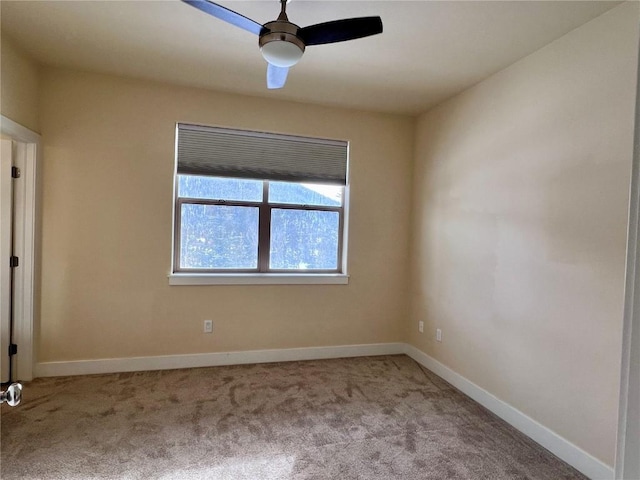 empty room featuring ceiling fan and light colored carpet