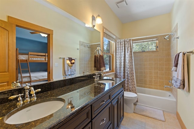 full bathroom with tile patterned flooring, vanity, toilet, and shower / bath combo with shower curtain