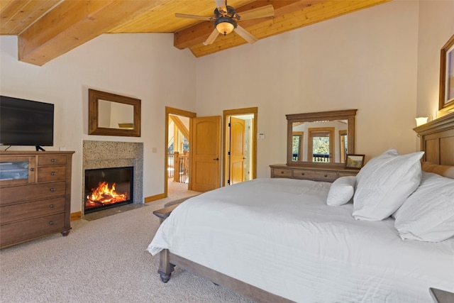 bedroom featuring wood ceiling, light colored carpet, ceiling fan, lofted ceiling with beams, and a fireplace