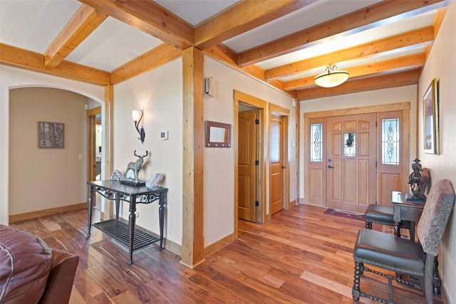 foyer entrance with beamed ceiling and hardwood / wood-style floors