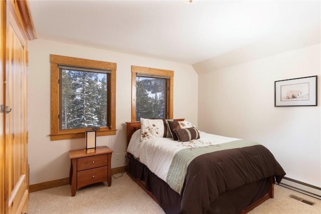 carpeted bedroom featuring baseboard heating and lofted ceiling