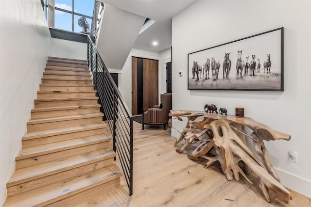 stairs with hardwood / wood-style flooring