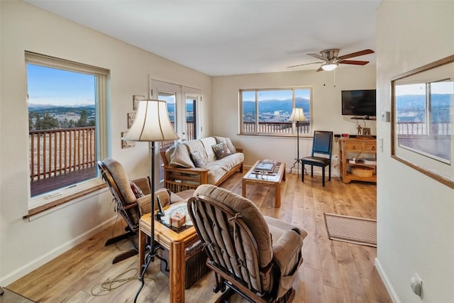 living room with french doors, light hardwood / wood-style flooring, and ceiling fan