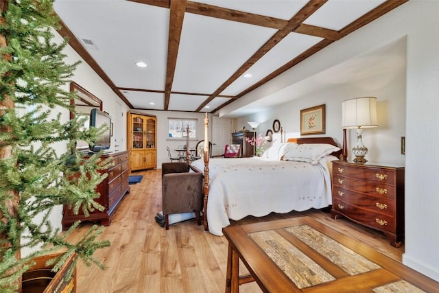 bedroom featuring beam ceiling and light wood-type flooring