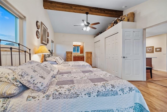 bedroom featuring multiple closets, ceiling fan, beamed ceiling, and hardwood / wood-style flooring