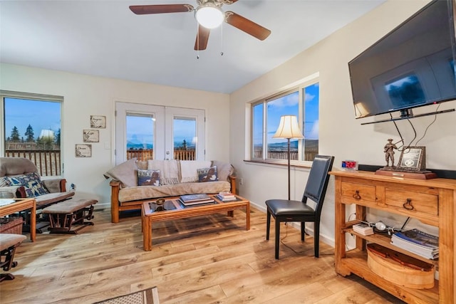 sitting room featuring ceiling fan, french doors, and light hardwood / wood-style flooring