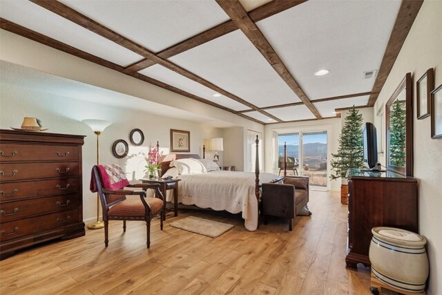 bedroom with beam ceiling, light wood-type flooring, and coffered ceiling