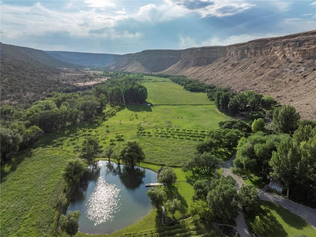 aerial view featuring a rural view and a water and mountain view