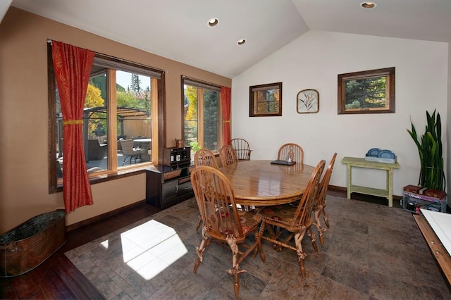 dining room with vaulted ceiling and dark wood-type flooring