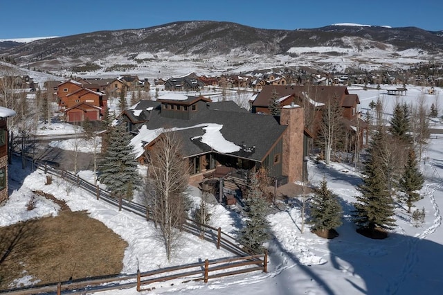 snowy aerial view featuring a mountain view