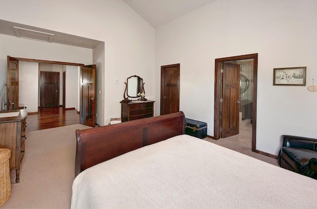 carpeted bedroom with high vaulted ceiling and a closet