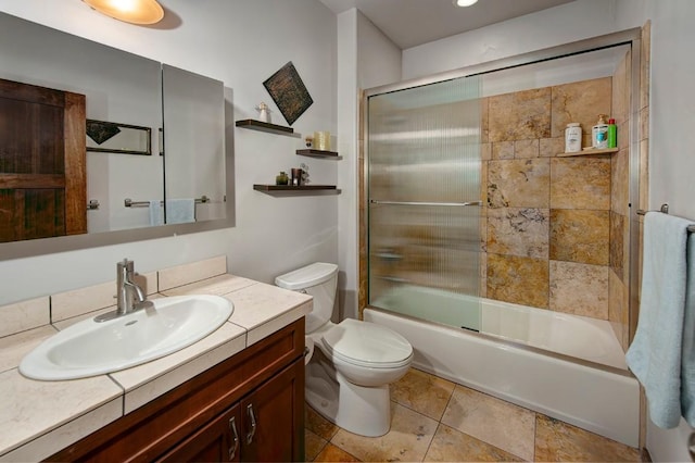 full bathroom with shower / bath combination with glass door, vanity, and toilet