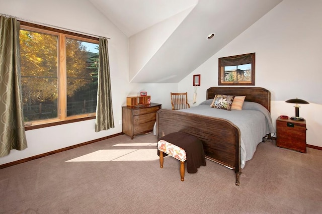 bedroom with light colored carpet and lofted ceiling