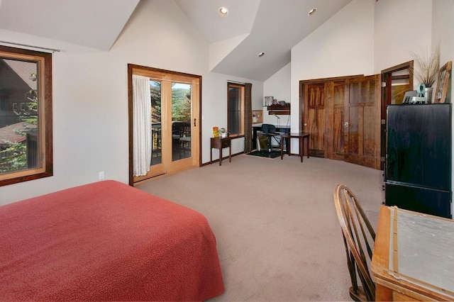 carpeted bedroom with access to exterior, high vaulted ceiling, and french doors