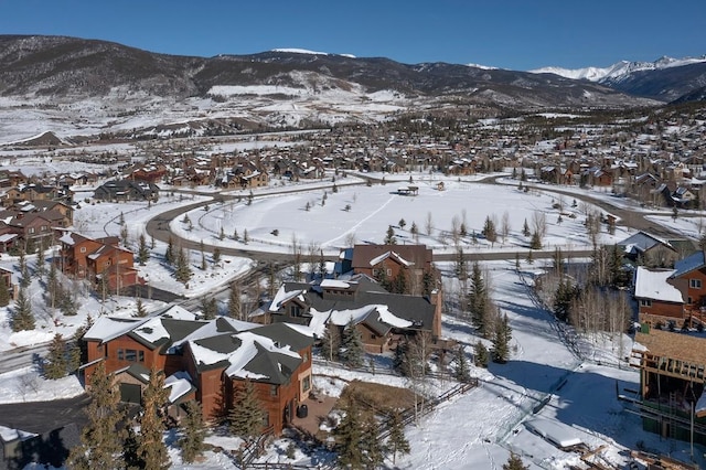 snowy aerial view with a mountain view