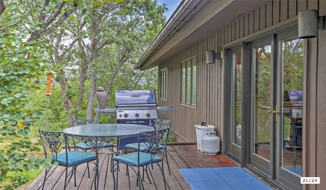 wooden terrace featuring outdoor dining area