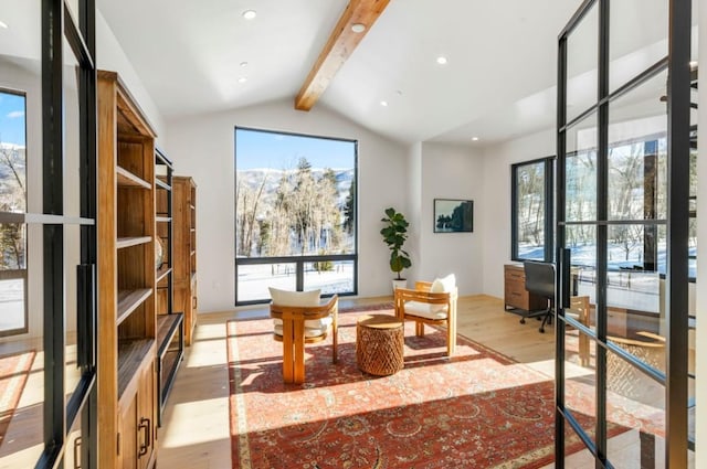 interior space featuring lofted ceiling with beams and light wood-type flooring