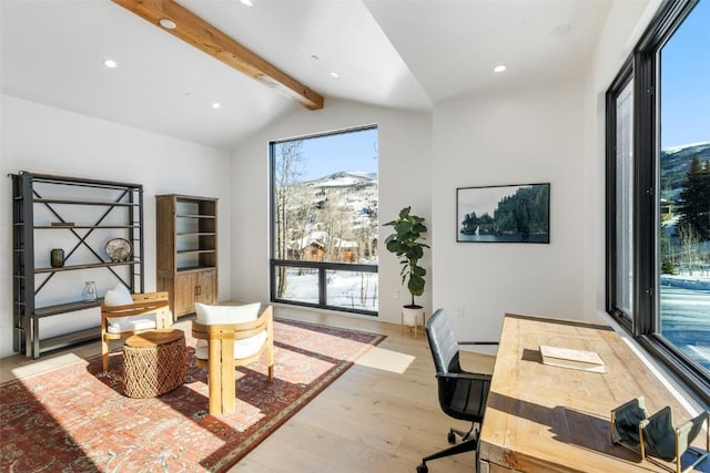 office area featuring lofted ceiling with beams, a mountain view, and light wood-type flooring