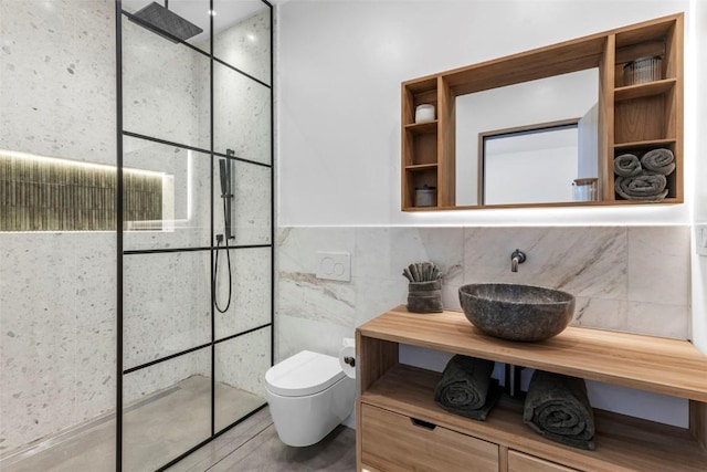 bathroom with toilet, vanity, tile walls, and walk in shower