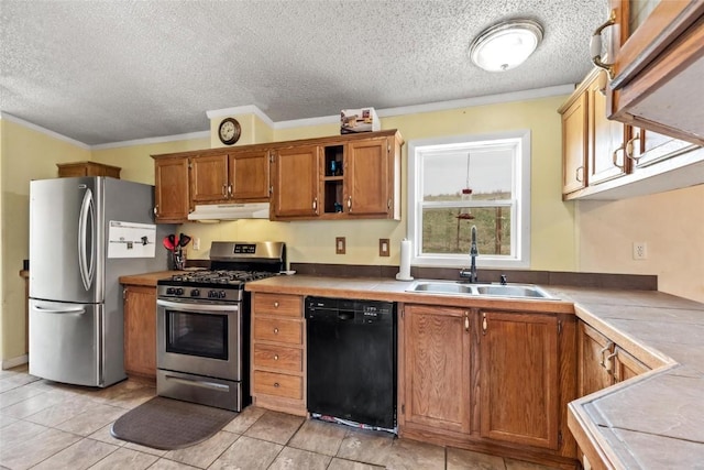 kitchen with ornamental molding, tile counters, stainless steel appliances, and sink