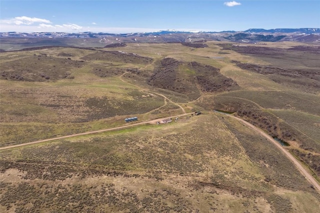 birds eye view of property with a mountain view and a rural view