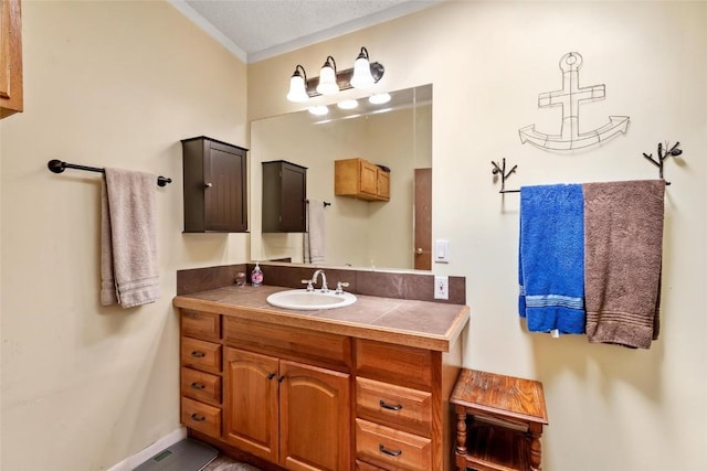 bathroom featuring a textured ceiling and vanity