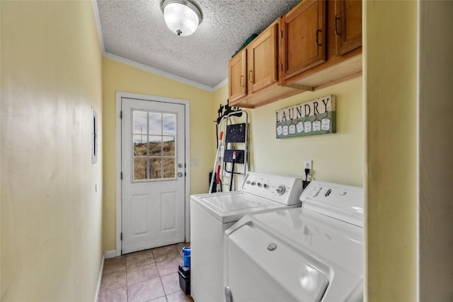 washroom featuring cabinets, ornamental molding, a textured ceiling, light tile patterned floors, and independent washer and dryer