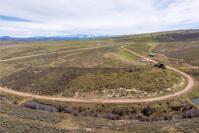 drone / aerial view featuring a mountain view and a rural view