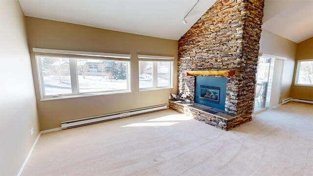 unfurnished living room with rail lighting, baseboard heating, lofted ceiling, a fireplace, and carpet