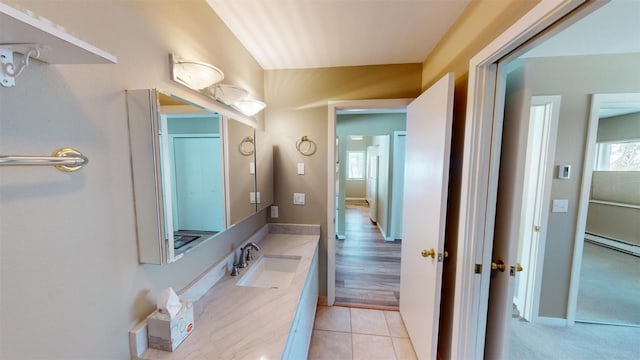 bathroom featuring tile patterned floors, vanity, and a baseboard radiator