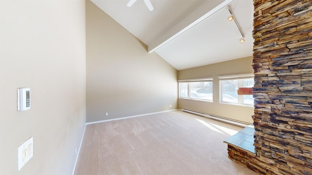 unfurnished living room featuring ceiling fan, a baseboard heating unit, light colored carpet, track lighting, and lofted ceiling